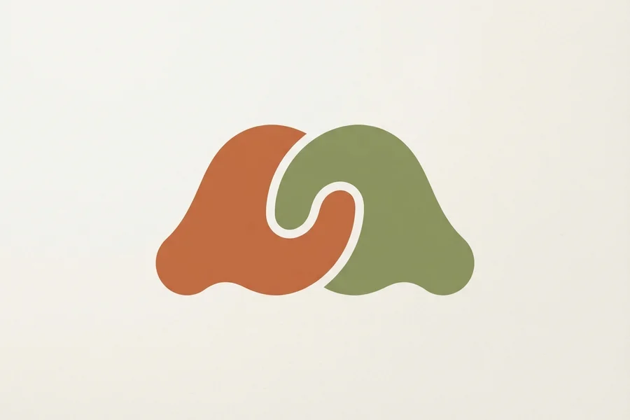 Two interlocking abstract shapes, one rust-orange and one sage-green, fitted together like puzzle pieces.